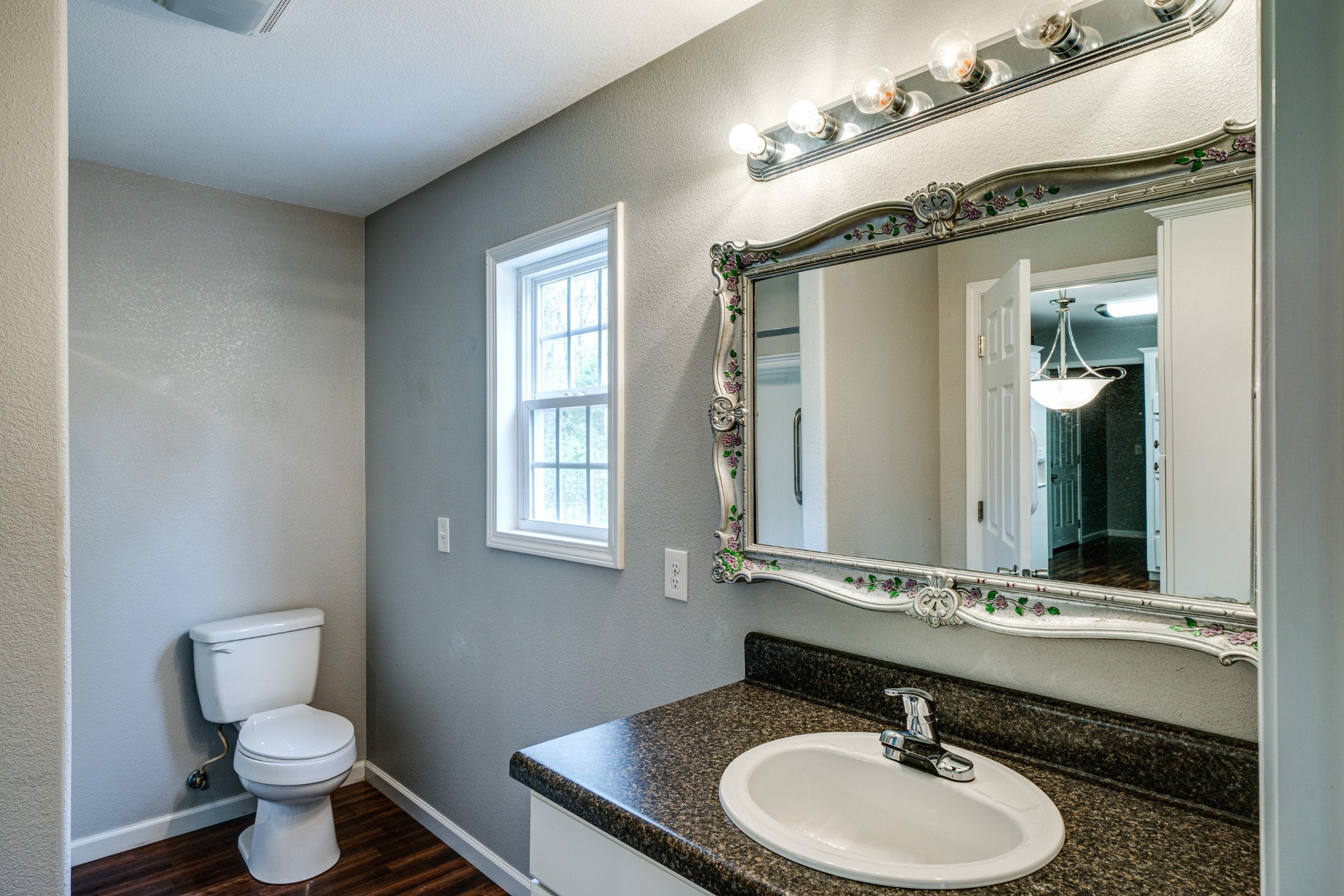 0 Lloyd Hall Loop Deer Lodge, TN 37726 - Photo 22 of 46 a bathroom with a granite countertop sink toilet a large mirror and a window