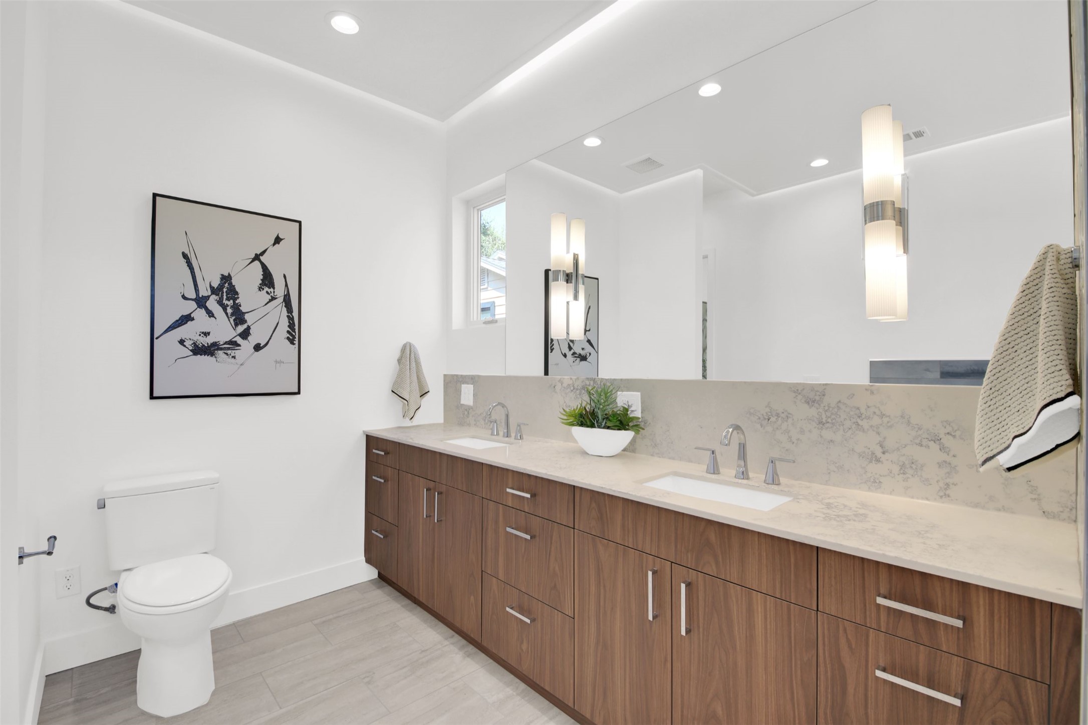 1310 Cullen Avenue Austin, TX 78757 - Photo 18 of 40 Full bathroom featuring double vanity, backsplash, recessed lighting, and large format tile floors