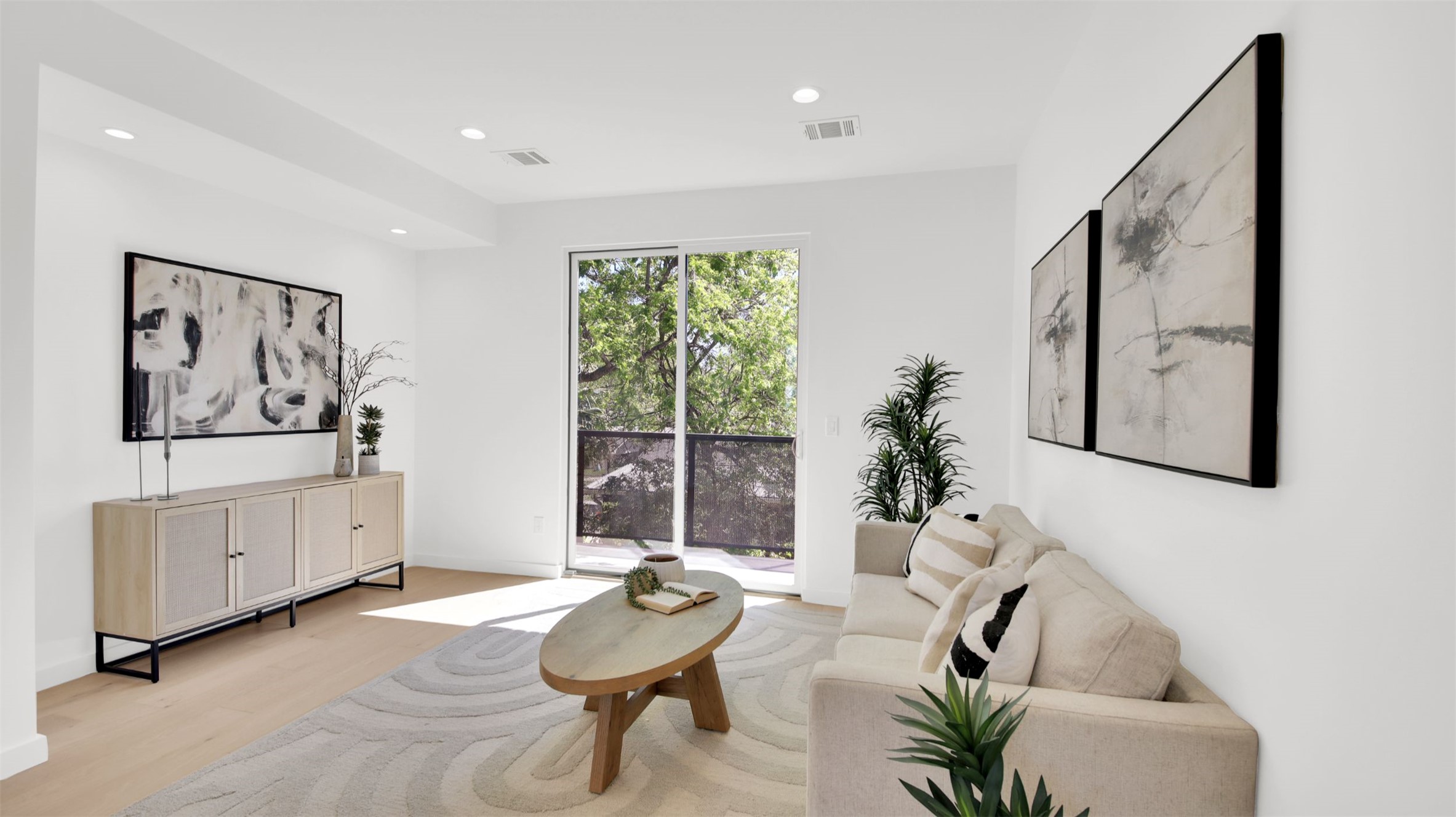1310 Cullen Avenue Austin, TX 78757 - Photo 27 of 40 Living room with light wood flooring and recessed lighting with access to balcony