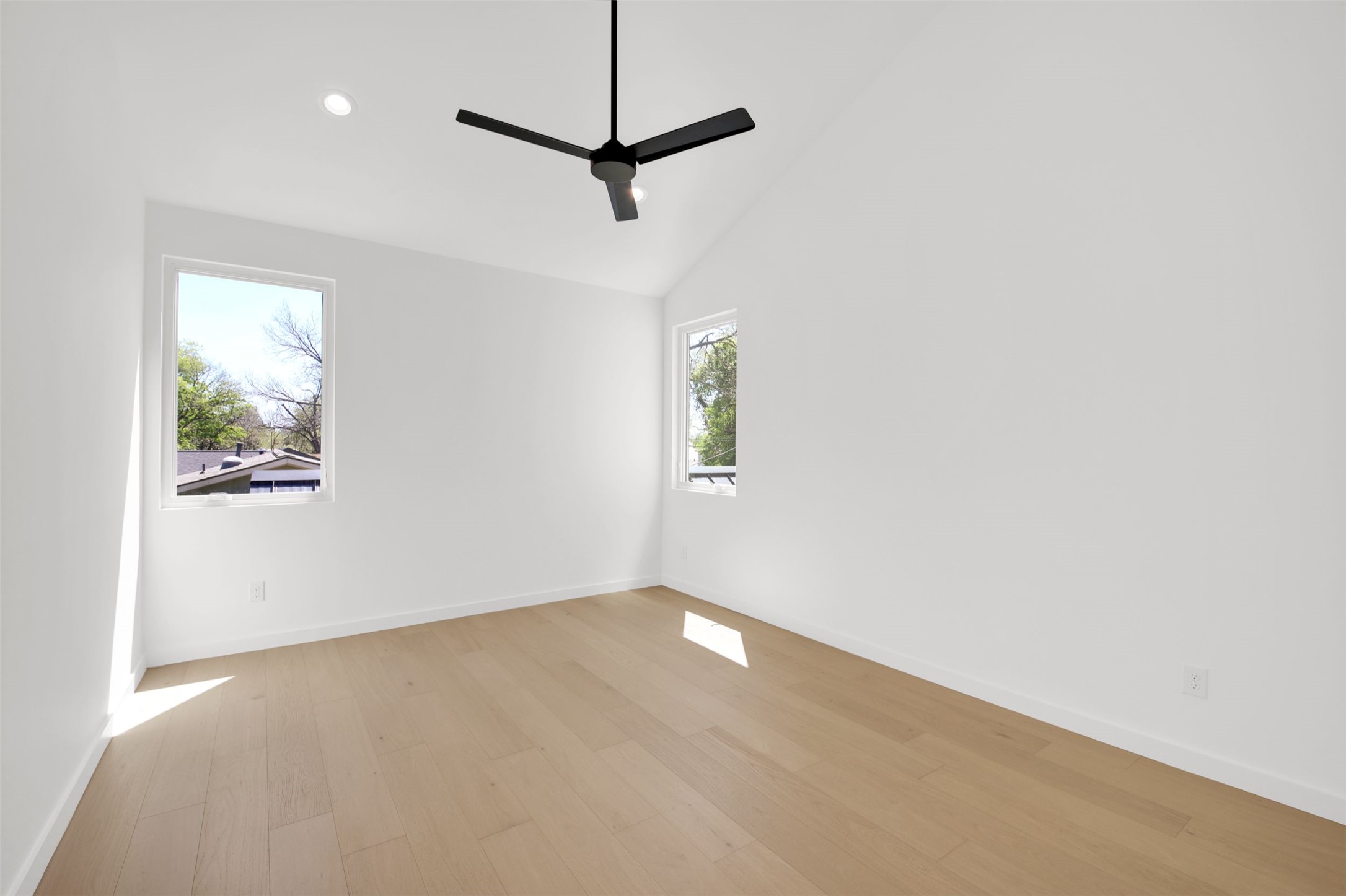 1310 Cullen Avenue Austin, TX 78757 - Photo 29 of 40 Guest Suite Bedroom with private attached bath and balcony access, featuring light wood floors, a ceiling fan, lofted ceiling, and recessed lighting.