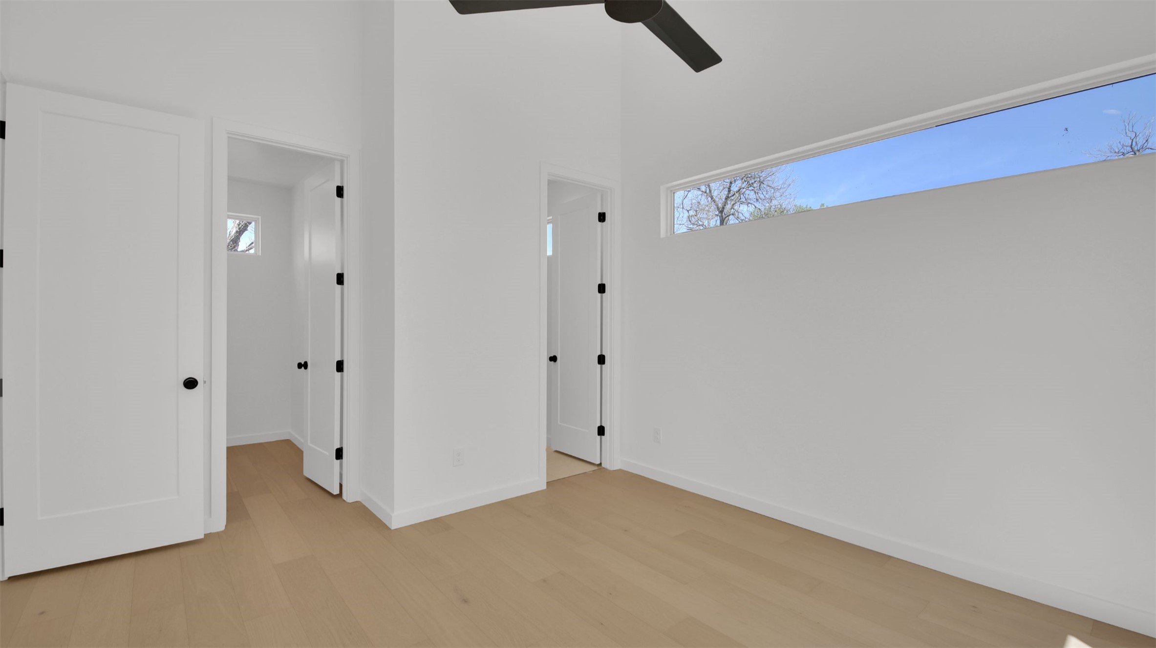 1310 Cullen Avenue Austin, TX 78757 - Photo 32 of 40 Bedroom featuring light wood floors, multiple windows, a high ceiling, and a ceiling fan