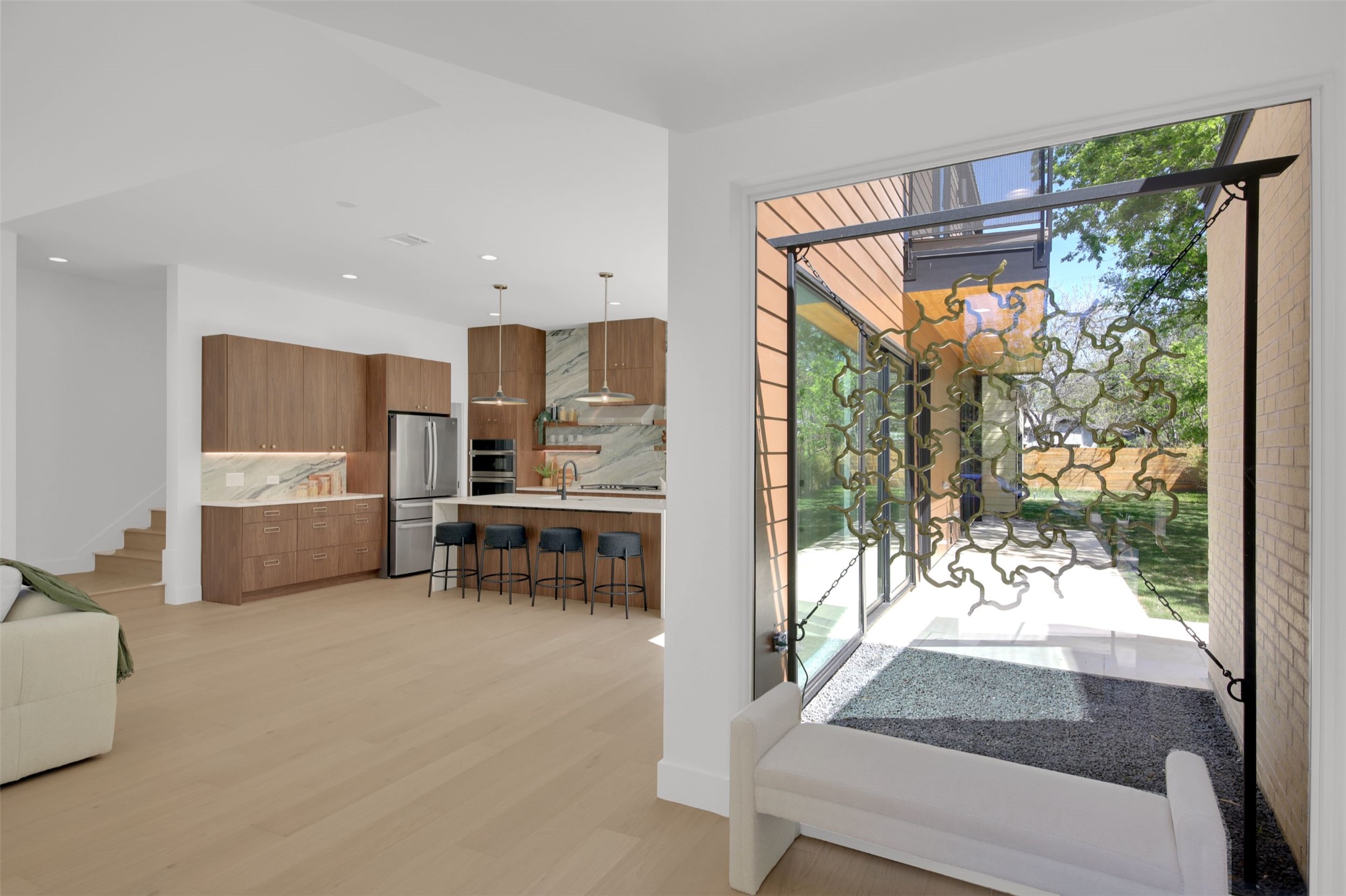 1310 Cullen Avenue Austin, TX 78757 - Photo 5 of 40 Entryway featuring wood finished floors and recessed lighting and custom design metal artwork