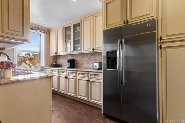 a kitchen with stainless steel appliances granite countertop a refrigerator and a sink