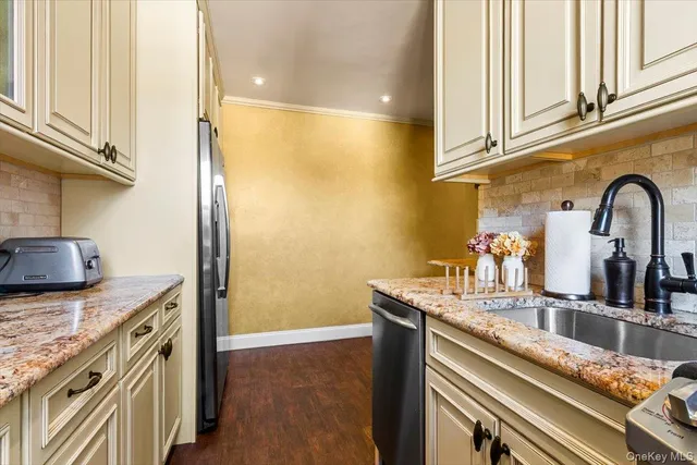 a kitchen with stainless steel appliances granite countertop a sink and cabinets
