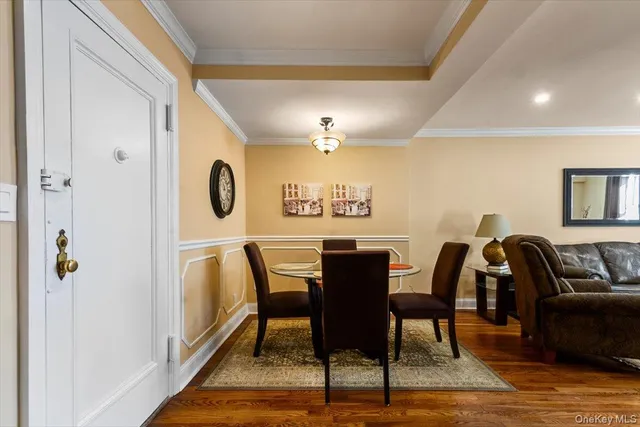 a view of a a dining room with furniture window and wooden floor