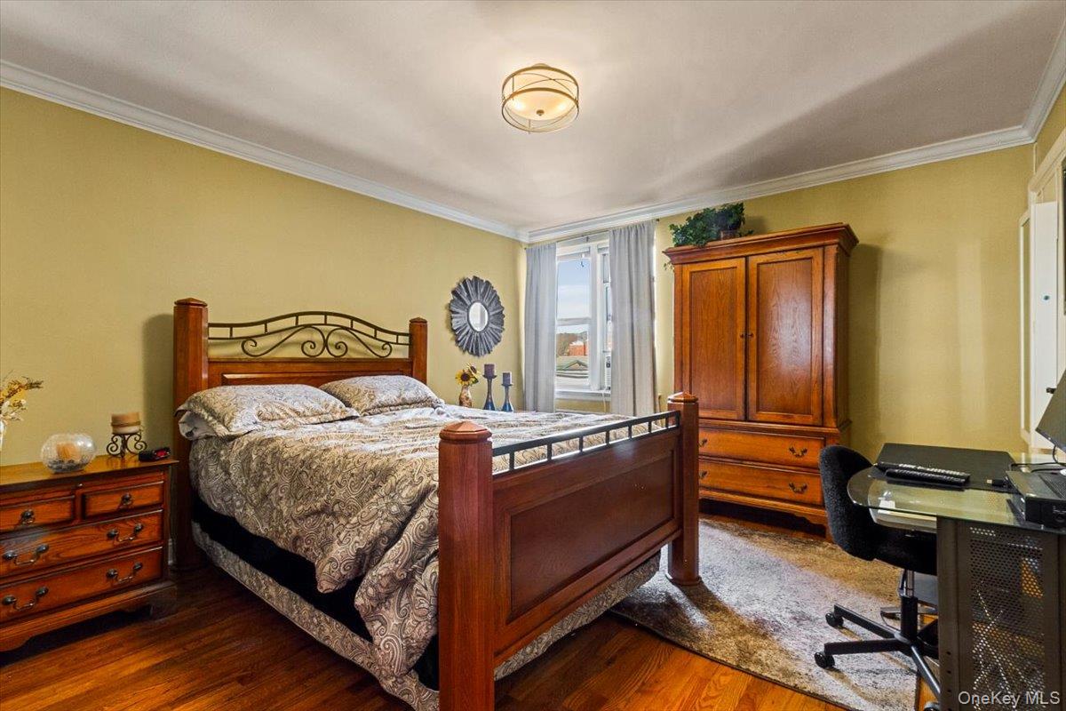 485 Bronx River Road, Unit C62 Yonkers, NY 10704 - Photo 10 of 21 a bedroom with a bed and a dresser next to a window