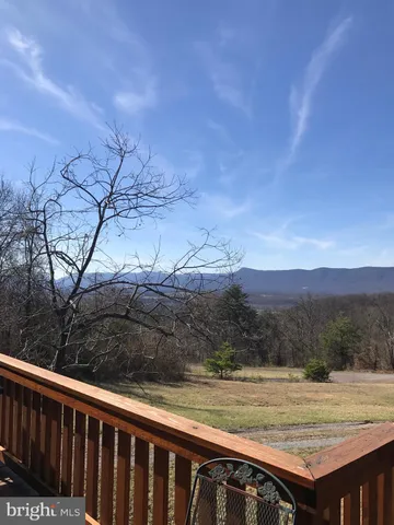 a view of a backyard with wooden fence and floor