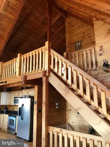 a bedroom with a bed and a view of balcony