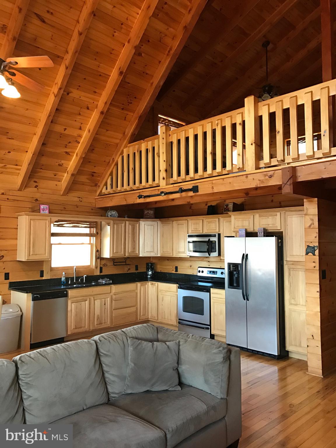 205 Meadow Hill Lane Rileyville, VA 22650 - Photo 35 of 53 a kitchen with stainless steel appliances granite countertop a refrigerator a stove and a sink