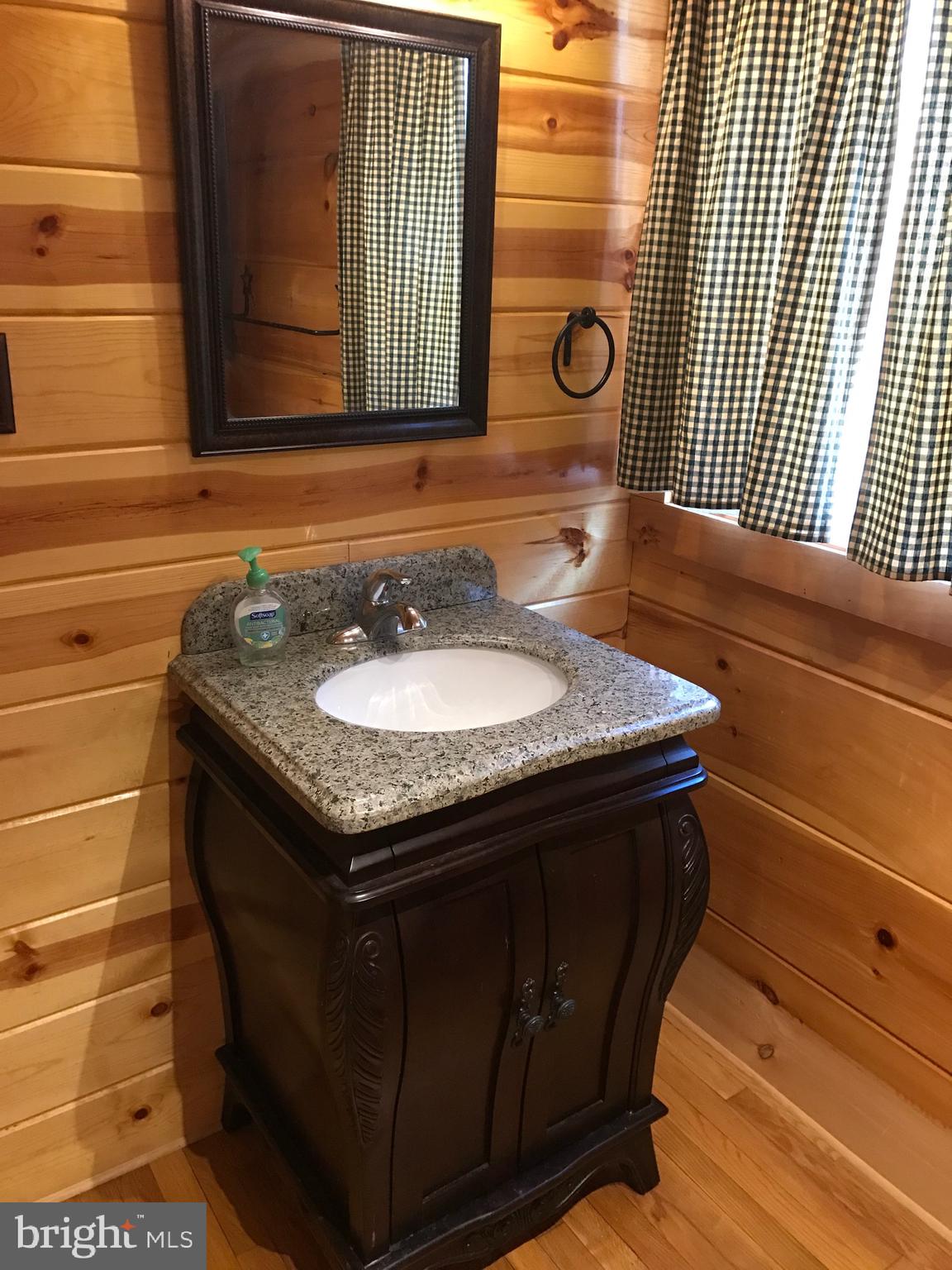 205 Meadow Hill Lane Rileyville, VA 22650 - Photo 4 of 53 a bathroom with a granite countertop sink and a mirror