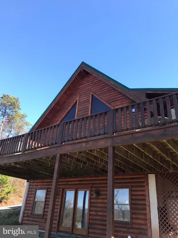 a large bed sitting in a bedroom next to a window