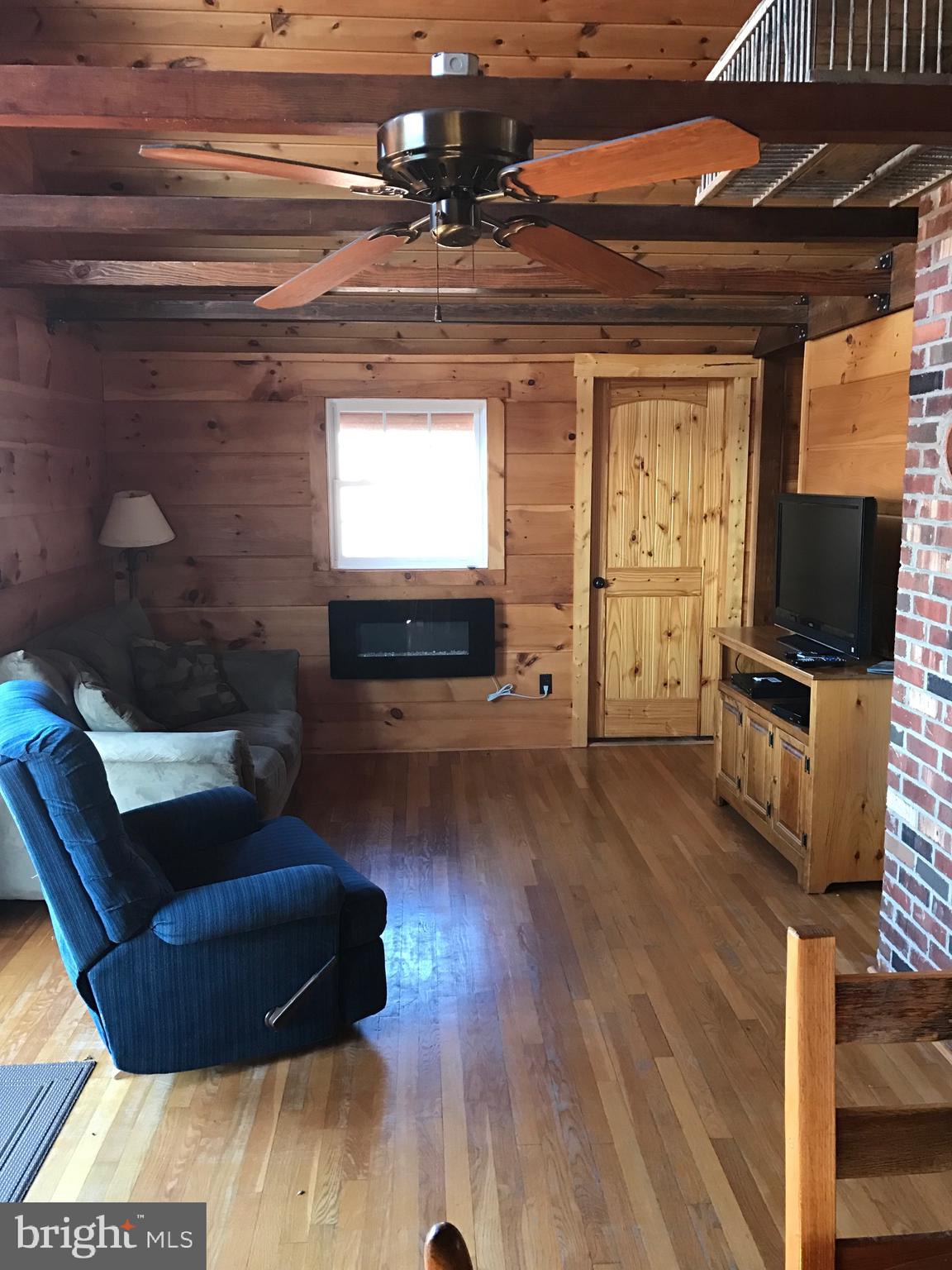 205 Meadow Hill Lane Rileyville, VA 22650 - Photo 8 of 53 a living room with furniture and a flat screen tv