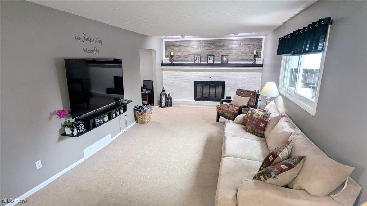 17567 Howe Road Strongsville, OH 44136 - Photo 22 of 30 View of Family Room with Updated Fireplace with Mantel, Carpeting, Window Treatments and Modern Paint