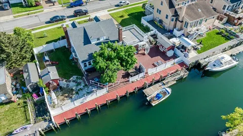 an aerial view of a house with a garden and lake view