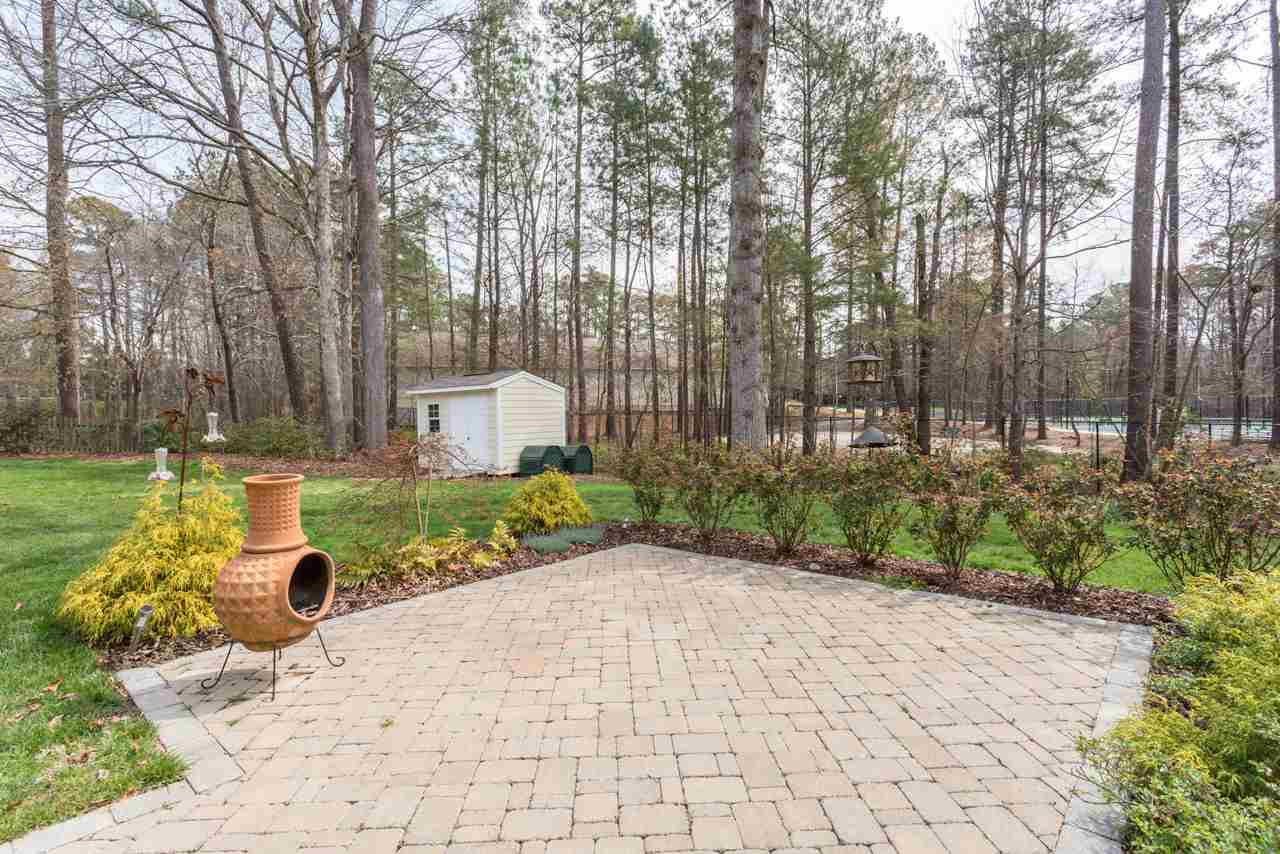 5600 Crossfield Drive Raleigh, NC 27613 - Photo 22 of 25 A paver-stone patio is encircled with rose bushes and offers yet another place for outdoor entertaining. Notice the detached storage shed that is located in the back corner of the yard. Paver-Stone Patio