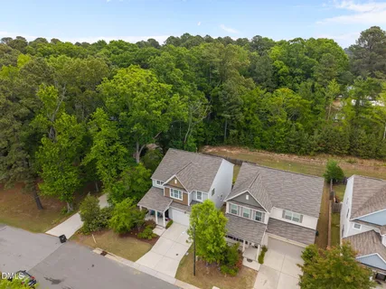 an aerial view of a house with a yard