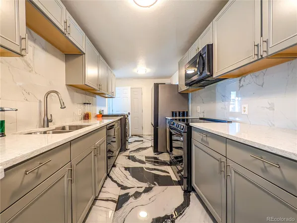 a kitchen with cabinets a sink and appliances
