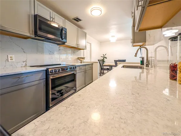 a kitchen with stainless steel appliances a stove a sink a stove and microwave