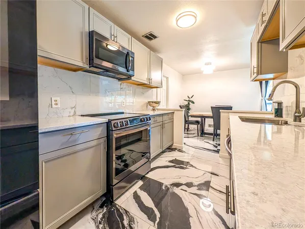 a kitchen with stainless steel appliances granite countertop a sink and cabinets