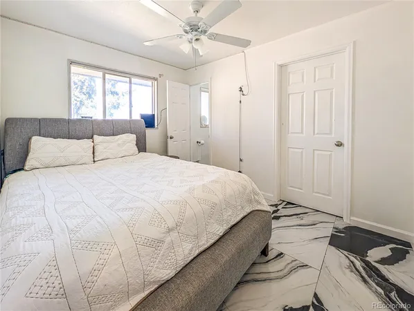 a spacious bedroom with a bed and a chandelier