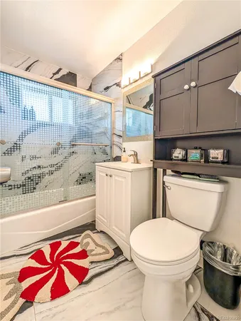 a bathroom with a sink a toilet and bathtub