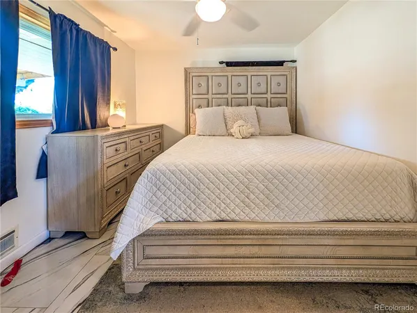 a bedroom with a large bed and a window