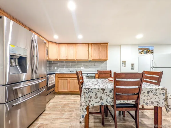a view of kitchen with granite countertop cabinets table and chairs