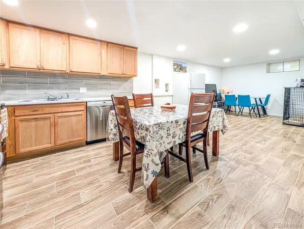 a kitchen with stainless steel appliances granite countertop table chairs sink and cabinets