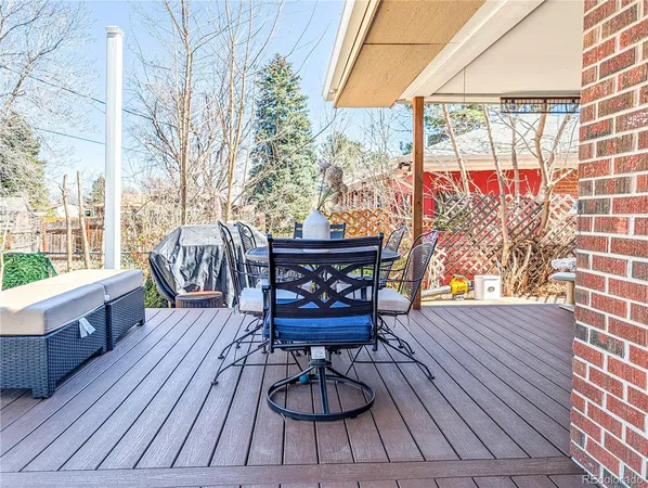 a view of a patio with table and chairs and wooden floor