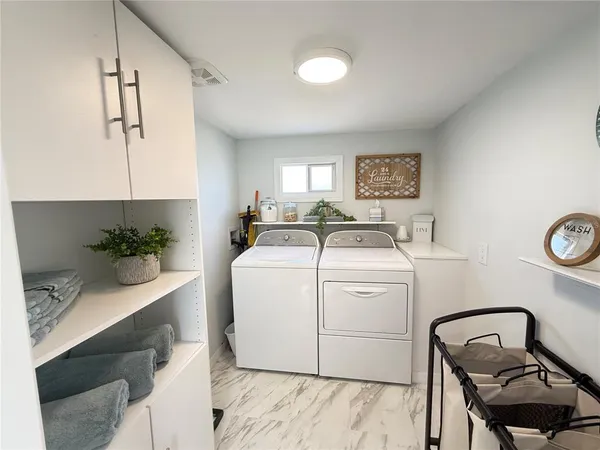 a view of a kitchen area with furniture and wooden floor