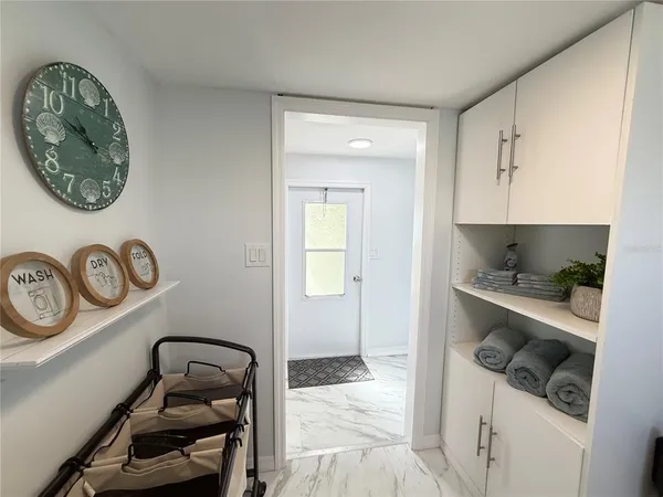 a room with a walk in closet and wooden floor