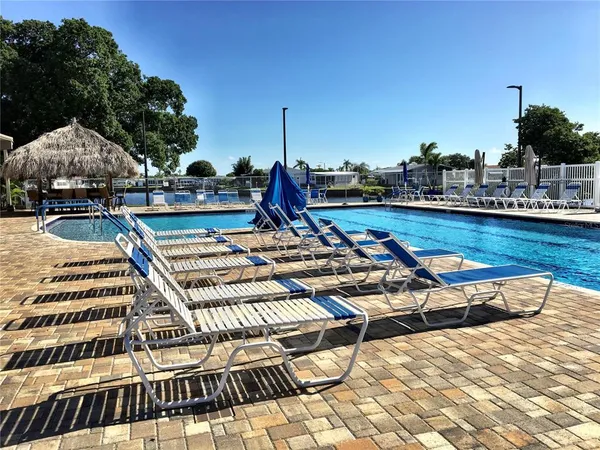 a view of a swimming pool with lounge chairs