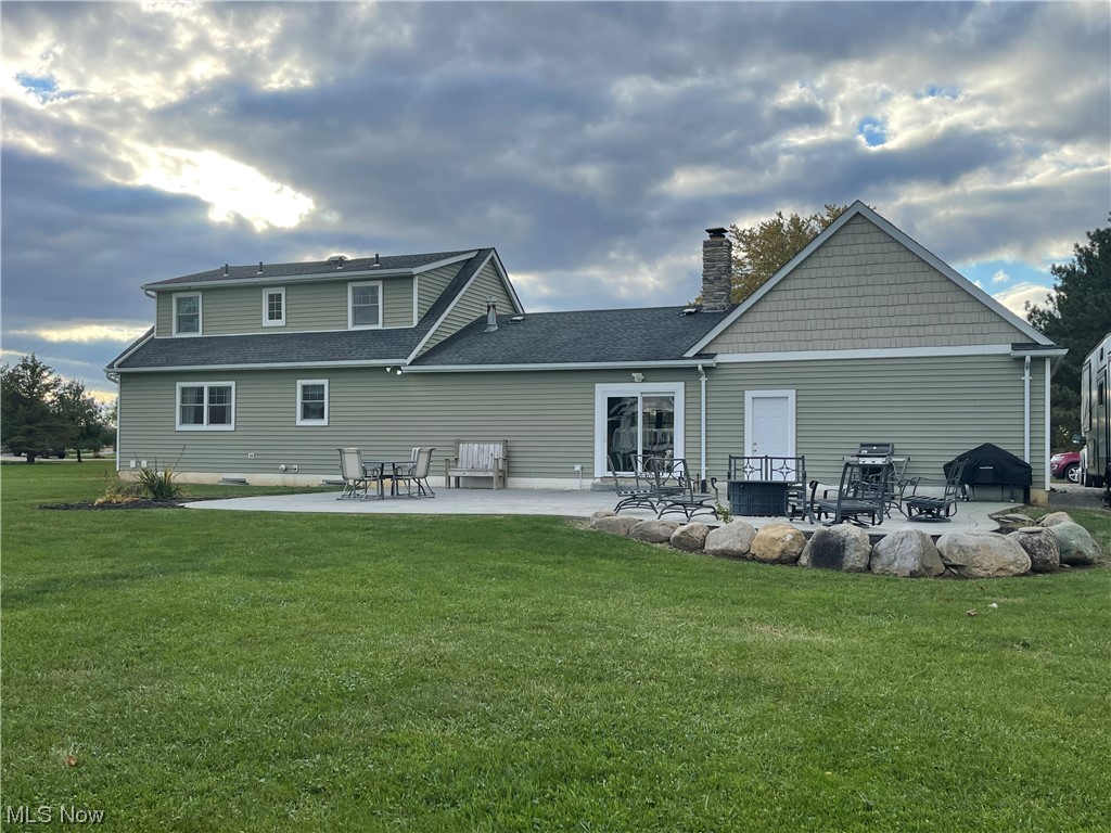 9104 Cherry Road Vermilion, OH 44089 - Photo 23 of 27 Back of house with a lawn and a patio