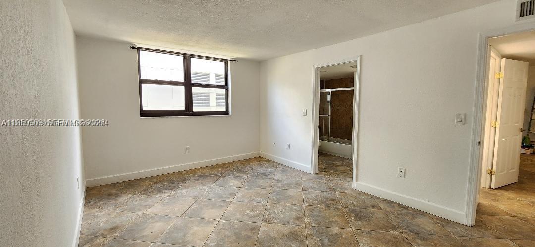 1621 Collins Avenue, Unit 404 Miami Beach, FL 33139 - Photo 12 of 26 an empty room with windows and closet
