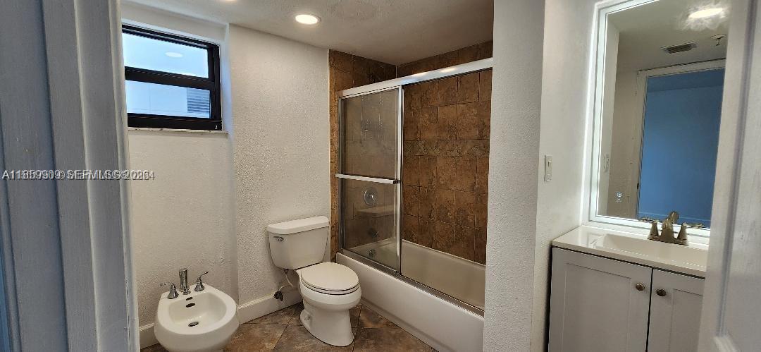 1621 Collins Avenue, Unit 404 Miami Beach, FL 33139 - Photo 14 of 26 a bathroom with a toilet a sink and shower