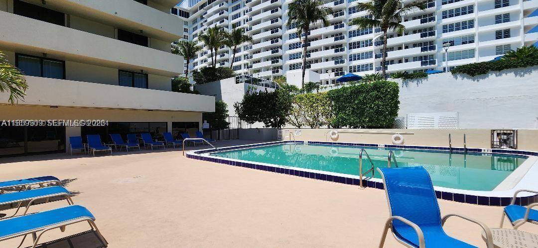 1621 Collins Avenue, Unit 404 Miami Beach, FL 33139 - Photo 18 of 26 a swimming pool with outdoor seating and yard