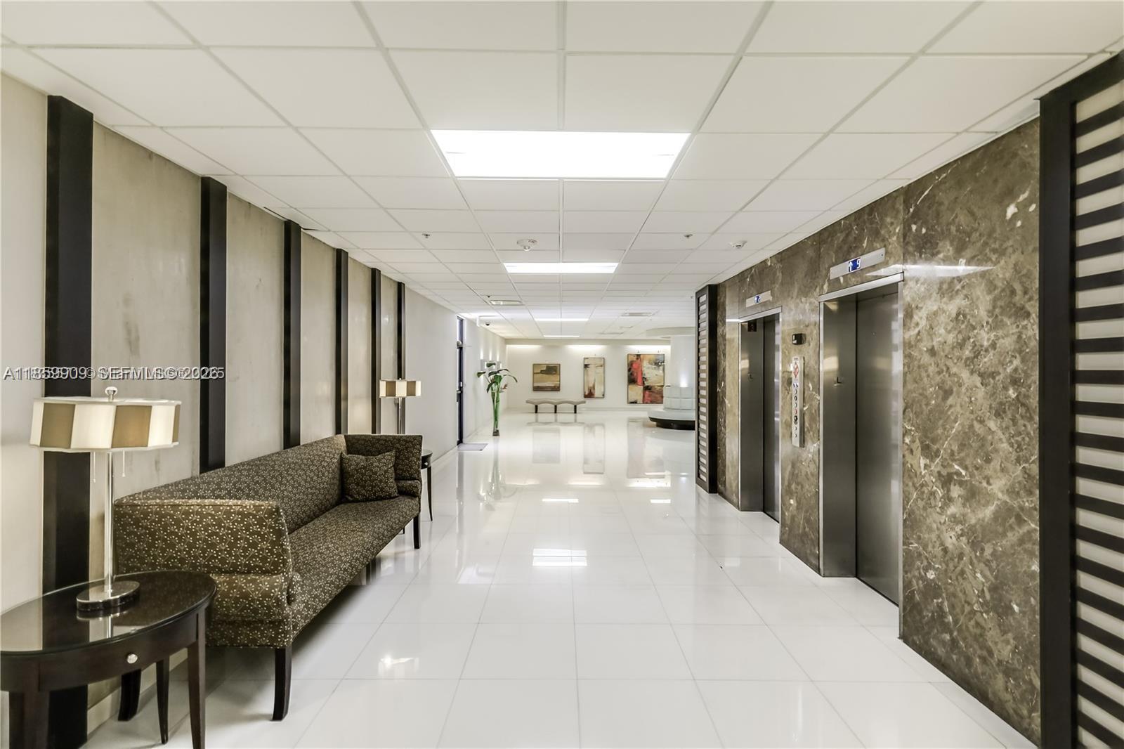 1621 Collins Avenue, Unit 404 Miami Beach, FL 33139 - Photo 26 of 26 a lobby with furniture and a large window