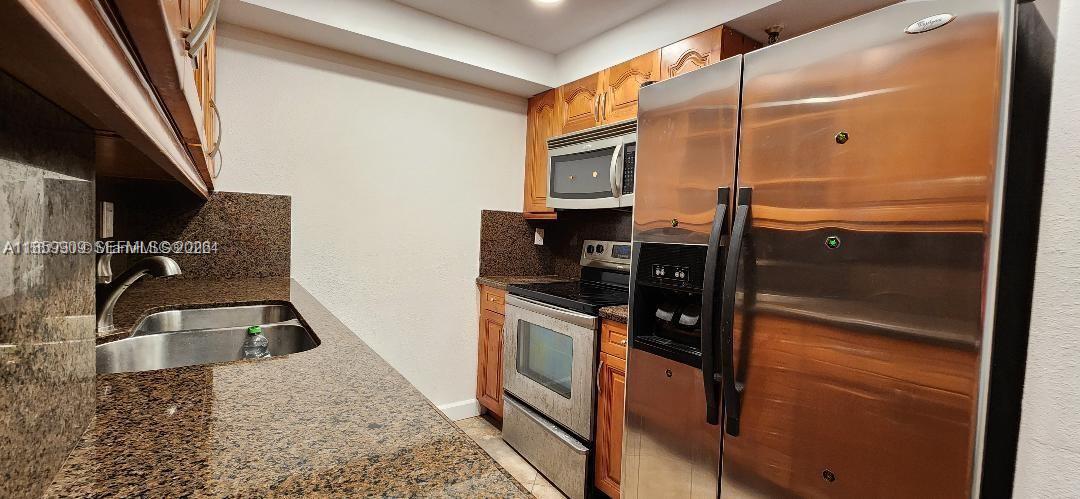 1621 Collins Avenue, Unit 404 Miami Beach, FL 33139 - Photo 4 of 26 a kitchen with a refrigerator wooden floor and a sink