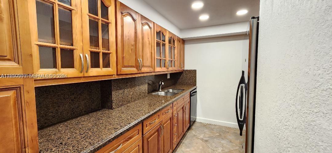 1621 Collins Avenue, Unit 404 Miami Beach, FL 33139 - Photo 5 of 26 a kitchen with stainless steel appliances granite countertop a refrigerator and a sink