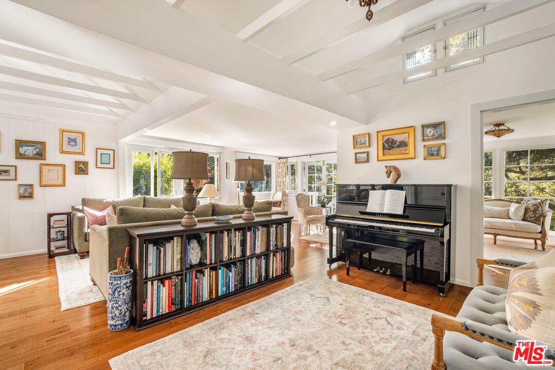 21714 Encina Road Topanga, CA 90290 - Photo 11 of 45 a living room with furniture and a book shelf