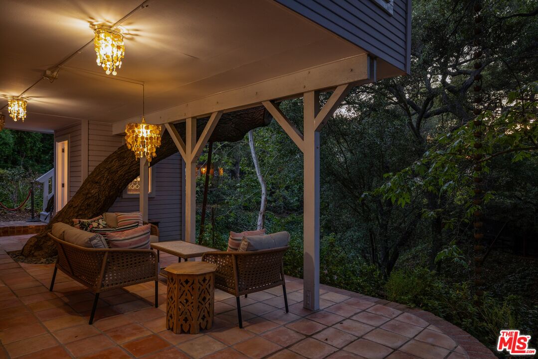 21714 Encina Road Topanga, CA 90290 - Photo 35 of 45 a view of a patio with table and chairs and potted plants