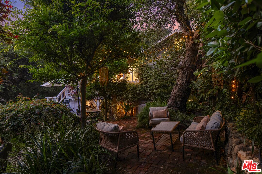 21714 Encina Road Topanga, CA 90290 - Photo 39 of 45 a view of a chairs and table in a backyard