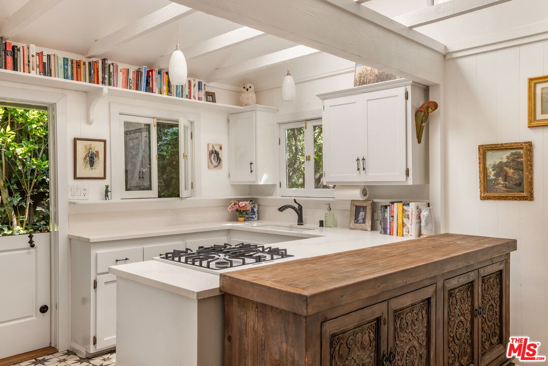 21714 Encina Road Topanga, CA 90290 - Photo 6 of 45 a kitchen with a stove a sink and a refrigerator