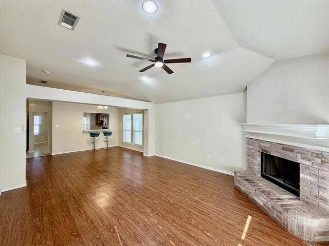wooden floor fireplace and windows in a room