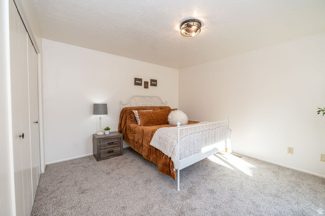 621 Coachman Way Riverdale, UT 84405 - Photo 22 of 38 Primary Bedroom with carpet flooring and a closet