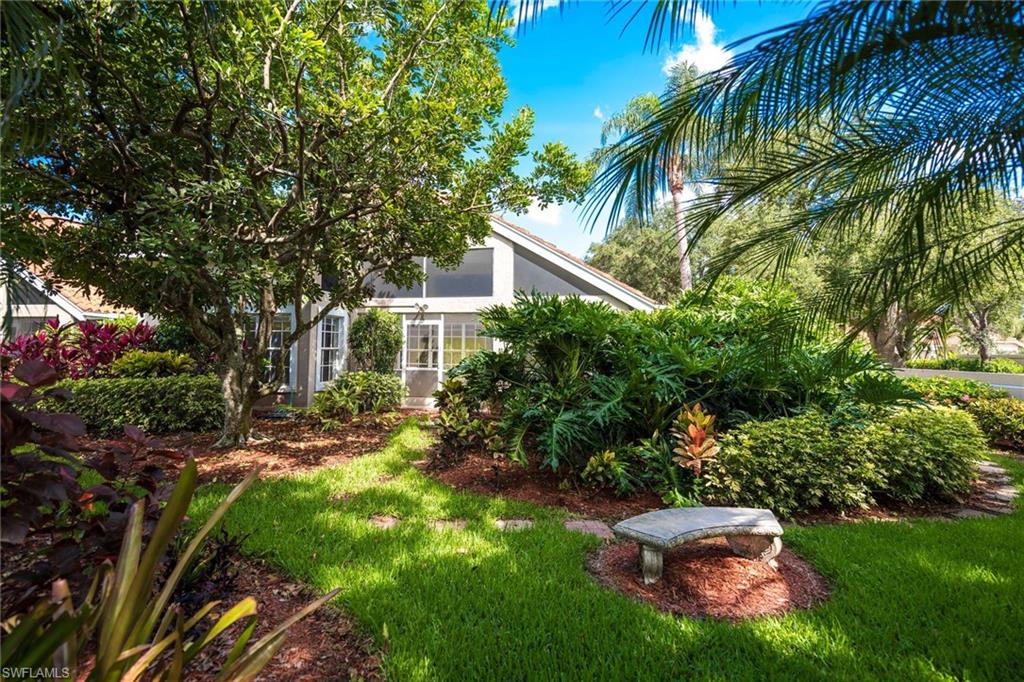 172 Napa Ridge Way Naples, FL 34119 - Photo 1 of 17 a backyard of a house with outdoor seating