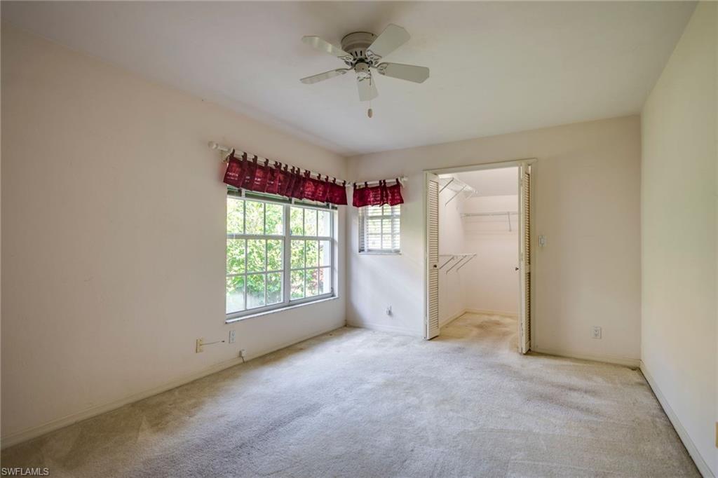 172 Napa Ridge Way Naples, FL 34119 - Photo 14 of 17 an empty room with windows and ceiling fan