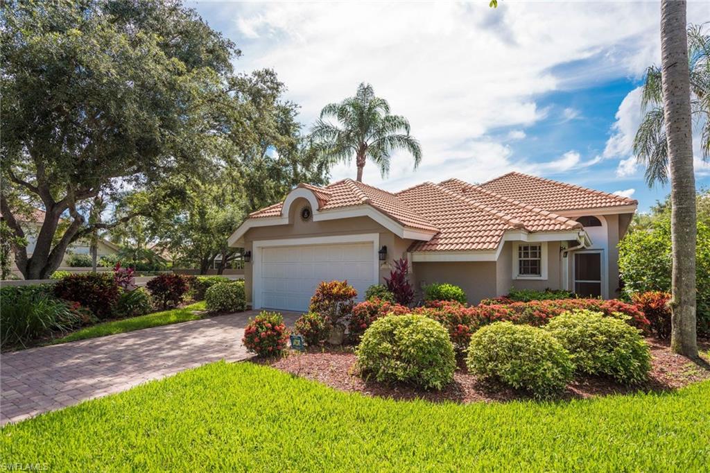 172 Napa Ridge Way Naples, FL 34119 - Photo 2 of 17 a front view of house with yard and green space