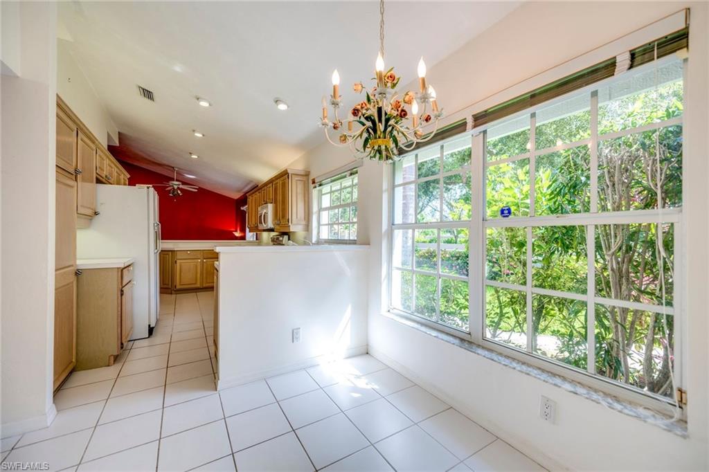 172 Napa Ridge Way Naples, FL 34119 - Photo 8 of 17 a open kitchen with a large window cabinets and stainless steel appliances