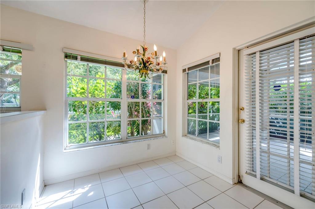 172 Napa Ridge Way Naples, FL 34119 - Photo 9 of 17 a view of room with window and floor to ceiling window